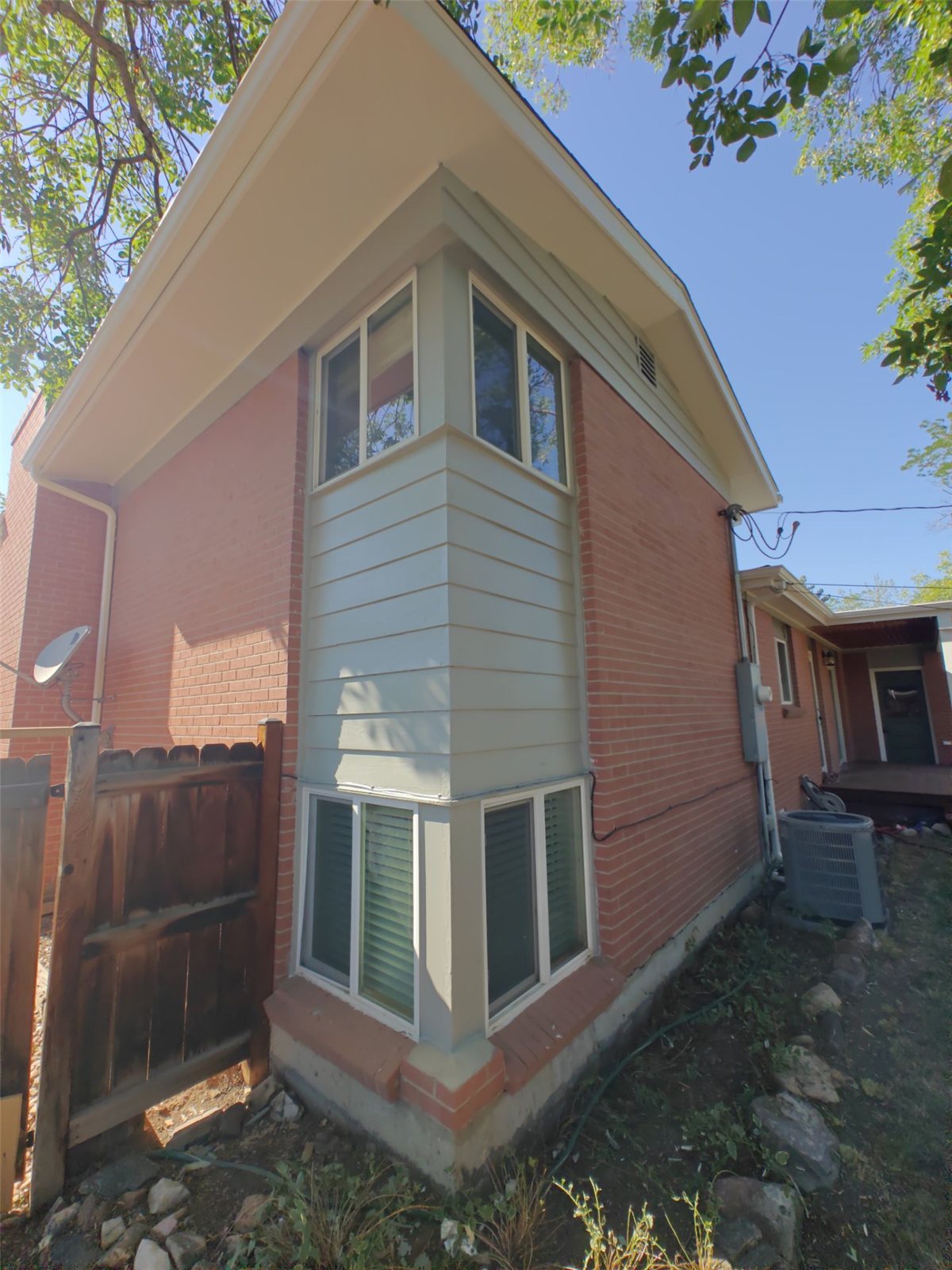 After: repaired siding corner, repainted and blended seamlessly with the surrounding boards